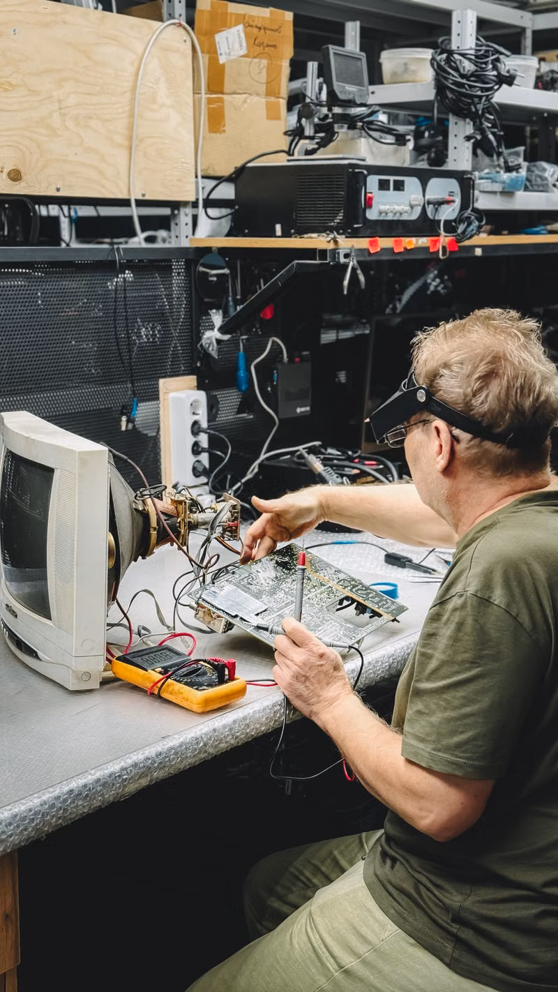 Computer technician testing a desktop computer and monitor