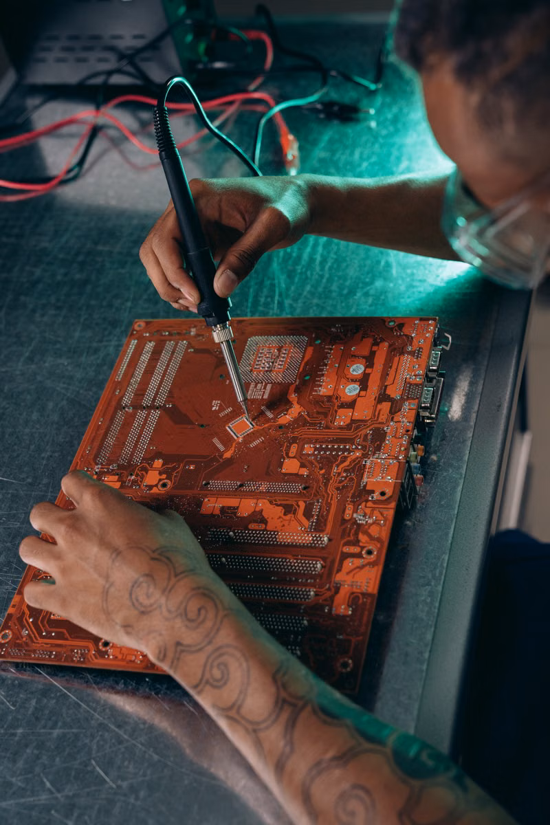 Close-up of a technician working on a computer motherboard